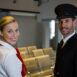 Portrait of happy pilot and air hostess standing in the airport terminal Portrait of happy pilot and air hostess standing in the airport terminal