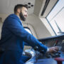 Professional driver sitting in cockpit and operating high speed train. Professional driver sitting in cockpit and operating high speed train.